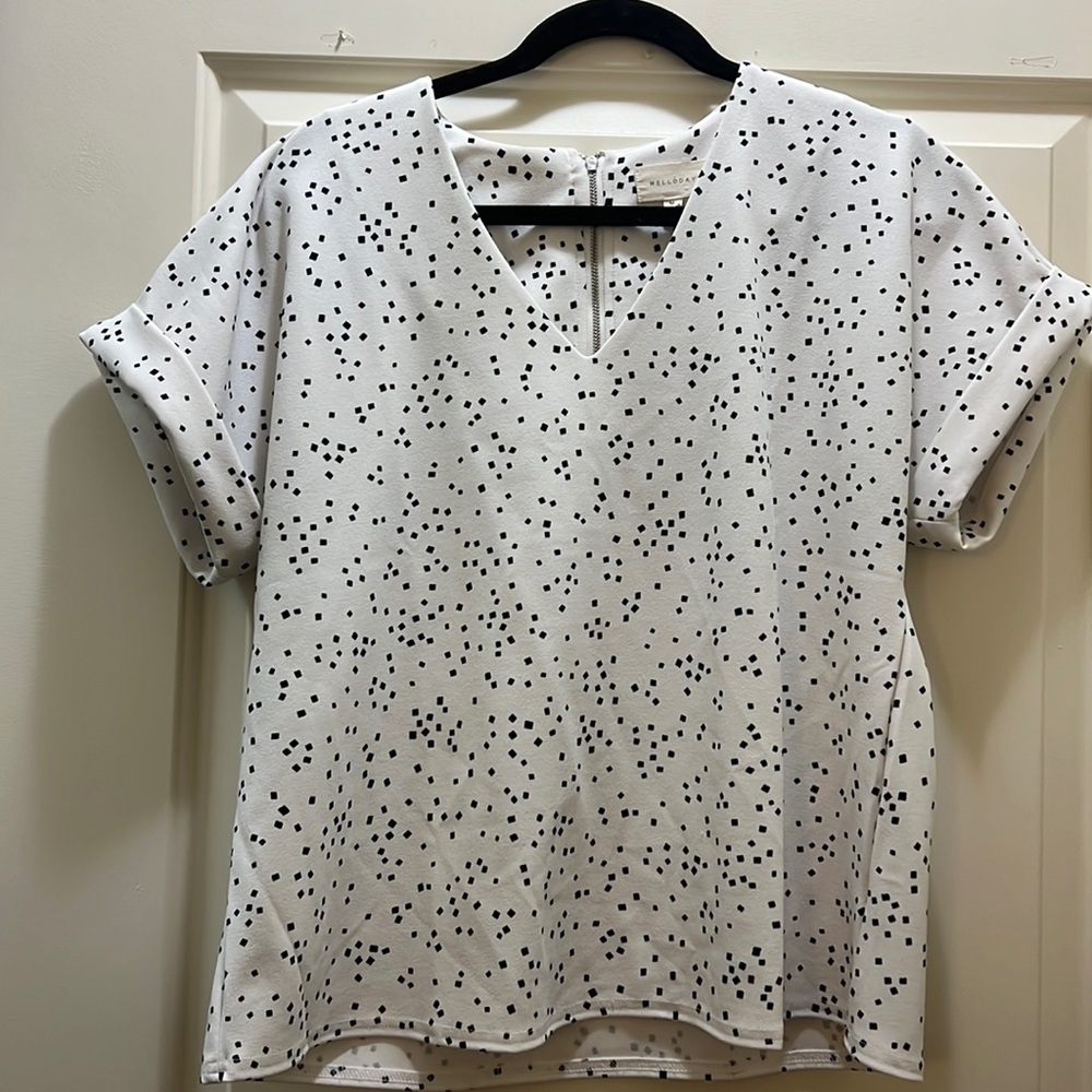 Melloday white shirt sleeve blouse with small black square design on it.